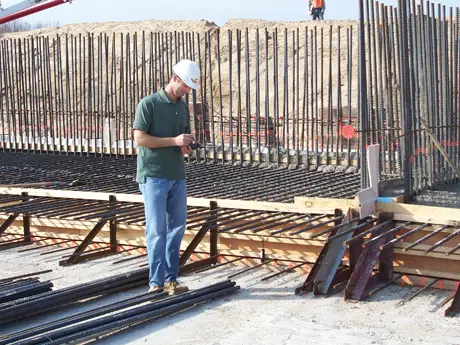 Engineer collecting HardTrack temperature data at the PARCC Side WWTP rebar mat